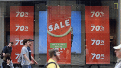 A Store Front With A Sign That Says Sale Up To 70 Percent Off GIF