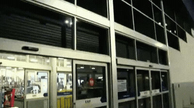 A Store Front With A Sliding Glass Door That Says Exit GIF