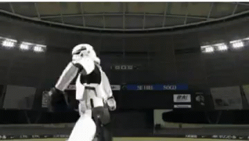 A Storm Trooper Is Standing In A Basketball Arena GIF