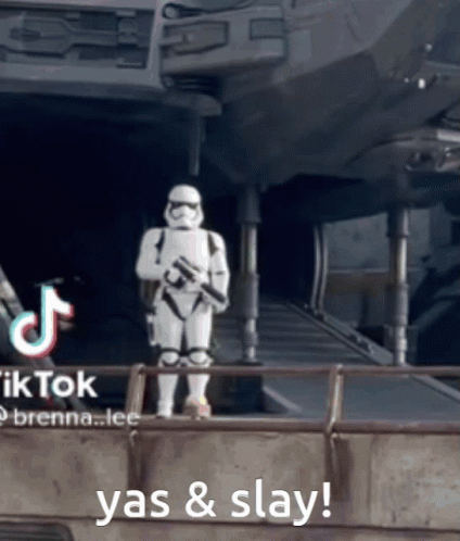 A Storm Trooper Is Standing In Front Of A Building With The Words Yas & Slay Behind Him GIF