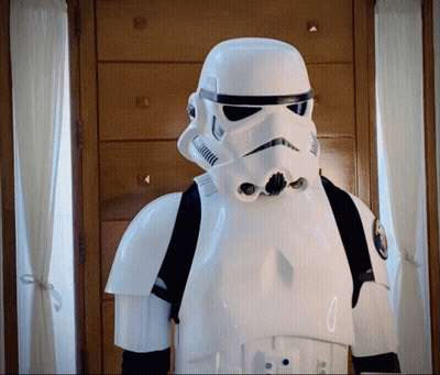 A Storm Trooper Stands In Front Of A Wooden Dresser GIF