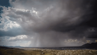 A Stormy Sky Over A City With A Few Clouds GIF