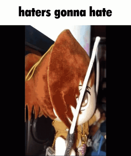 A Stuffed Animal Holding A Stick With The Words Haters Gonna Hate Written Below It GIF