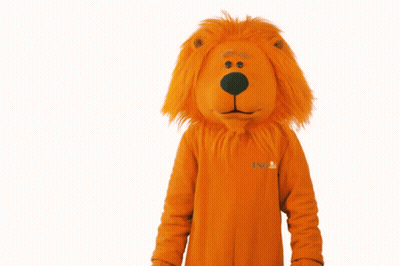 A Stuffed Animal In An Orange Lion Costume That Says ' Snl ' On The Front GIF