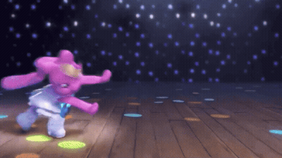 a stuffed animal is dancing on a wooden floor
