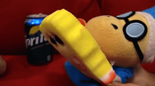 A Stuffed Animal Is Eating A Piece Of Ice Cream Next To A Sprite Can . GIF