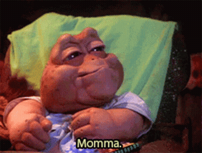 A Stuffed Animal Is Laying On A Couch And Says Momma GIF