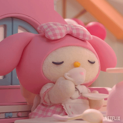 A Stuffed Animal Is Sitting At A Table With A Cup And Saucer And A Netflix Logo In The Corner GIF