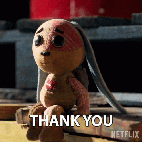 A Stuffed Animal Is Sitting On A Wooden Plank And Says Thank You GIF