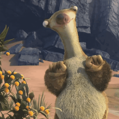 A Stuffed Animal Is Standing In Front Of A Plant GIF