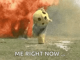 A Stuffed Animal Is Standing In Front Of An Explosion With The Words `` Me Right Now '' Written On It . GIF