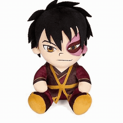 A Stuffed Animal Of A Boy With Black Hair And A Red Eye Is Sitting On A White Surface . GIF