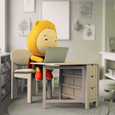 A Stuffed Animal Sitting At A Desk With A Laptop GIF