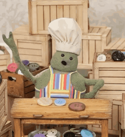 A Stuffed Animal Wearing A Chef 'S Hat And Apron GIF