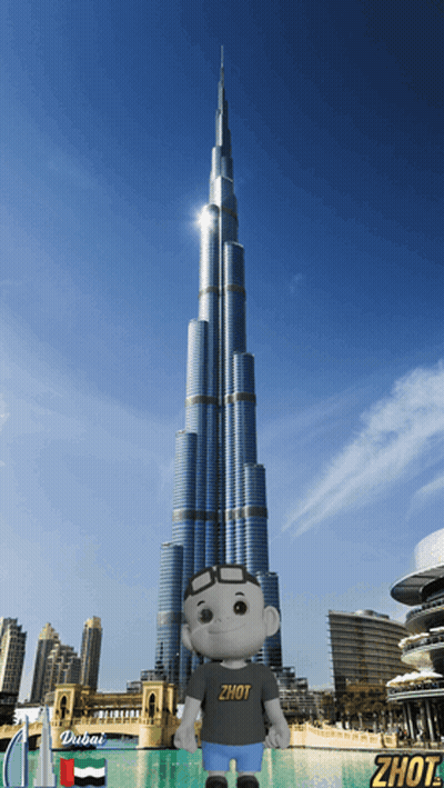 A Stuffed Animal Wearing A Shirt That Says Zhot Stands In Front Of A Dubai Skyscraper GIF