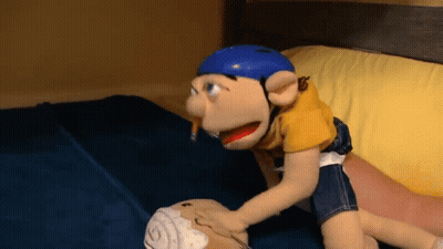A Stuffed Animal With A Blue Helmet On Is Laying On A Bed GIF