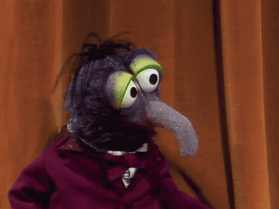 A Stuffed Animal With A Long Tongue And Big Eyes GIF