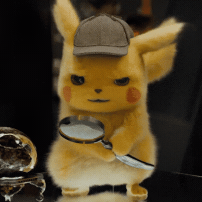 A Stuffed Animal With A Magnifying Glass And A Hat GIF
