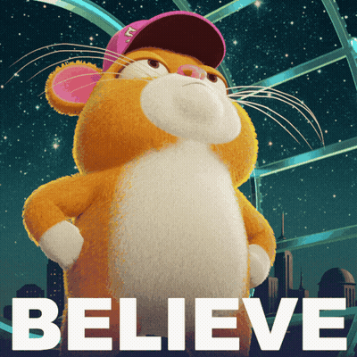A Stuffed Animal With A Pink Hat And The Word Believe Behind It GIF