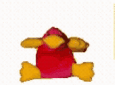 A Stuffed Animal With A Red Head And Yellow Arms Is Laying Down On A White Surface . GIF