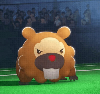 A Stuffed Animal With A Red Nose Is Standing On A Green Field In Front Of A Crowd GIF