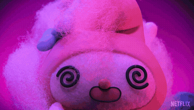 A Stuffed Animal With A Swirl In Its Eyes Is On A Purple Background With A Netflix Logo In The Corner GIF