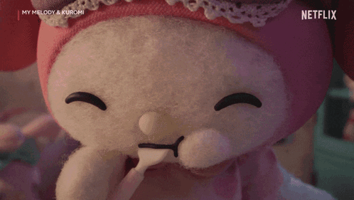 A Stuffed Animal With Heart Shaped Eyes And A Spoon In Its Mouth Is From Netflix . GIF