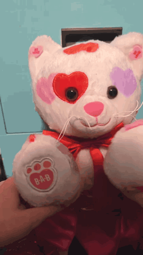 A Stuffed Animal With Hearts On Its Eyes And A Paw That Says B-A-B On It GIF