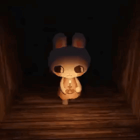A Stuffed Bunny Rabbit Is Holding A Candle In A Dark Room . GIF