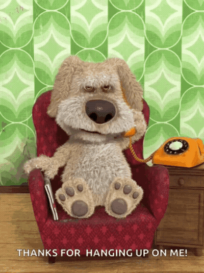 A Stuffed Dog Sitting In A Chair Talking On A Phone GIF