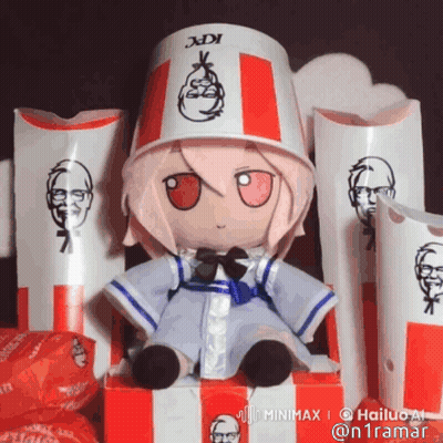 A Stuffed Doll Wearing A Kfc Bucket Hat Is Sitting In A Box GIF