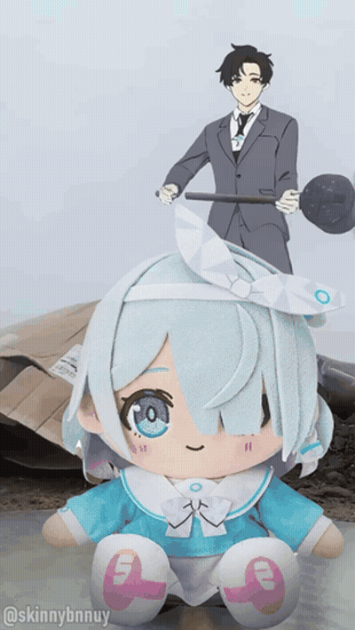A Stuffed Doll With The Number 9 On It Sits In Front Of A Man In A Suit GIF