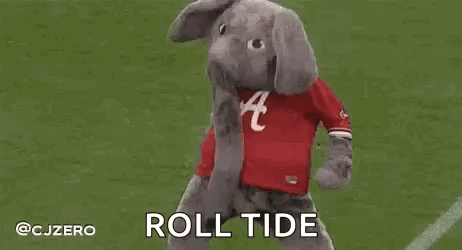 A Stuffed Elephant Mascot Is Standing On Top Of A Football Field . GIF