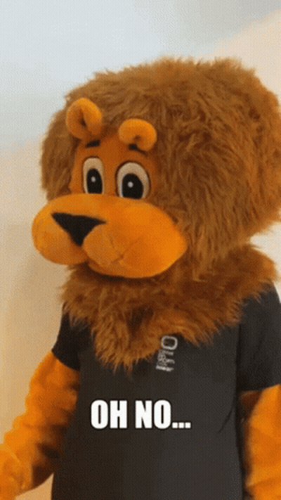 A Stuffed Lion Wearing A Black Shirt That Says Oh No On It GIF