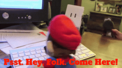 A Stuffed Mario Says Psst Hey Folk Come Here In Front Of A Computer GIF
