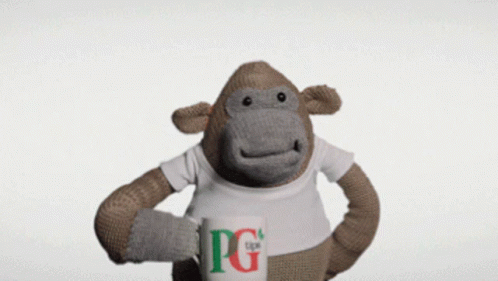 A Stuffed Monkey Is Holding A Pg Tips Mug GIF