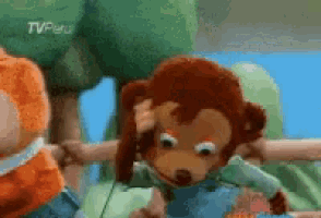 A Stuffed Monkey Is Holding Another Stuffed Monkey 'S Head In A Cartoon Scene . GIF
