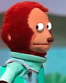 A Stuffed Monkey Wearing A Green Shirt Is Making A Funny Face GIF