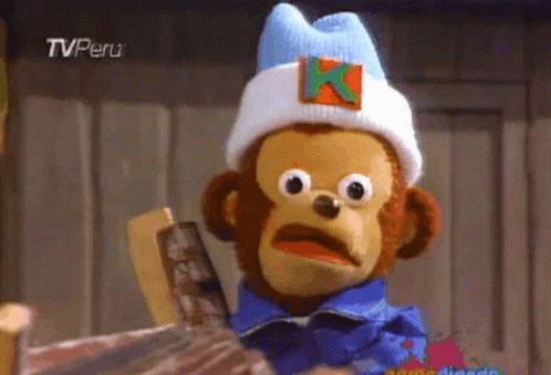A Stuffed Monkey Wearing A Hat With A Letter K On It GIF