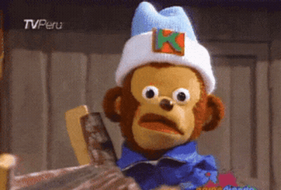 A Stuffed Monkey Wearing A White Hat With A K On It GIF