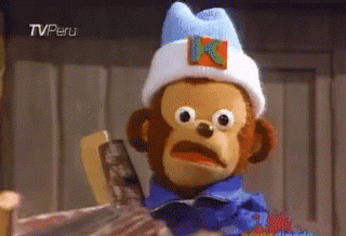 A Stuffed Monkey Wearing A White Hat With A K On It GIF