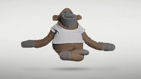 A Stuffed Monkey Wearing A White T-Shirt Is Flying Through The Air GIF