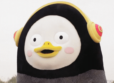 A Stuffed Penguin With A Yellow Beak And Headphones GIF