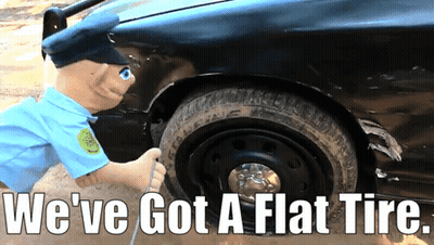 A Stuffed Police Officer Is Pumping Air Into A Flat Tire With The Caption We 'Ve Got A Flat Tire GIF