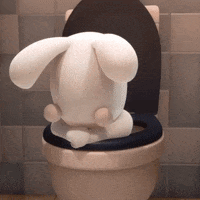 A Stuffed Rabbit Is Sitting On A Toilet GIF