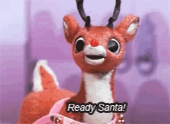 A Stuffed Reindeer With A Red Nose Is Holding A Pink Bow And Saying `` Ready Santa '' . GIF