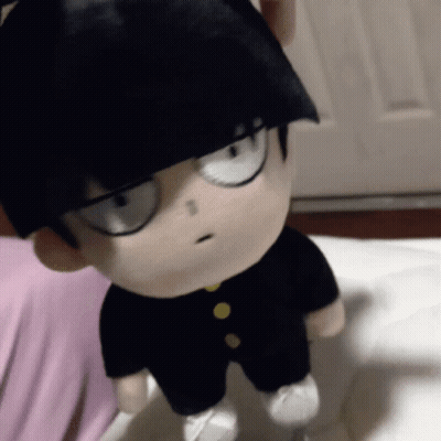 A Stuffed Toy Of A Boy With Black Hair And Glasses GIF