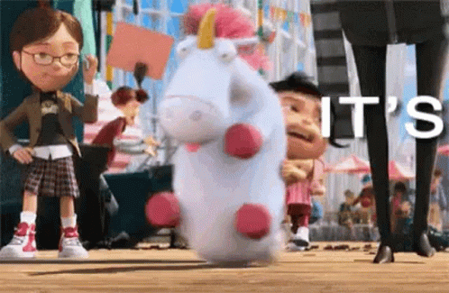 A Stuffed Unicorn From The Movie Despicable Me Is Standing On A Wooden Floor . GIF