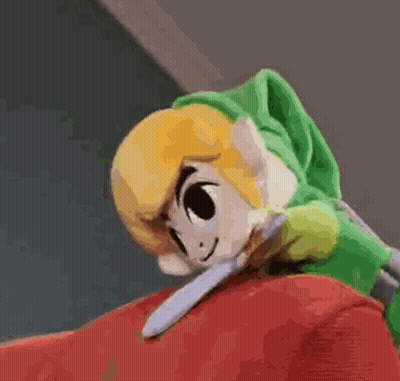 A Stuffed Zelda Link Is Laying On Top Of A Red Couch . GIF