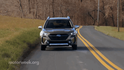 A Subaru Suv Is Driving Down A Road With Motorweek.org Written In The Corner GIF